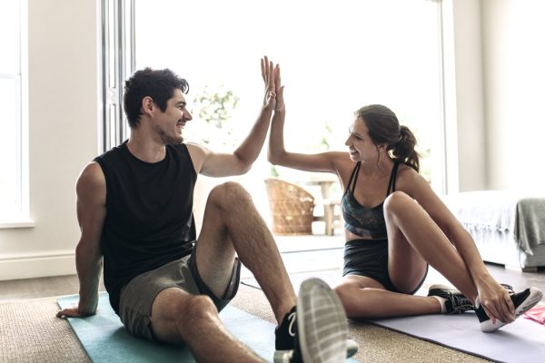 Couple doing a high five after a couples yoga session