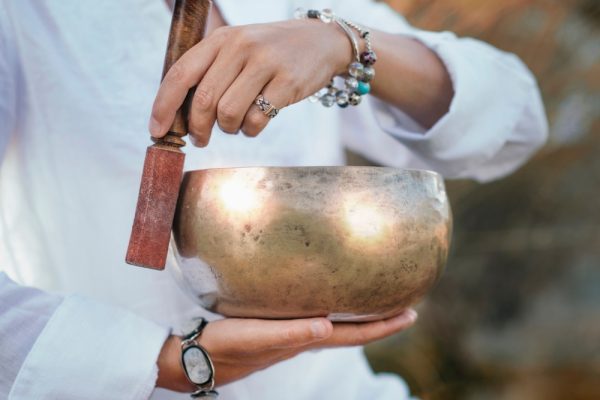 Woman with a golden Tibetan sound bowl