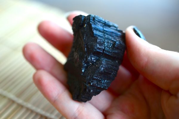 Hand holding black tourmaline