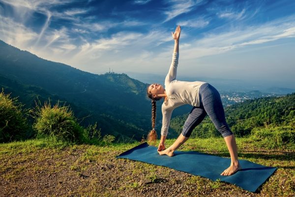 Female yogi practicing yoga in nature