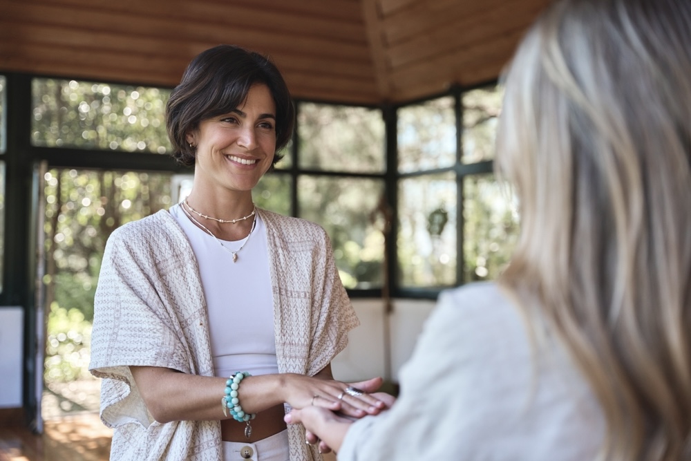 Meditation teacher holding the hand of a student