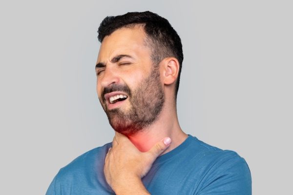 Man having health issues sore throat problem