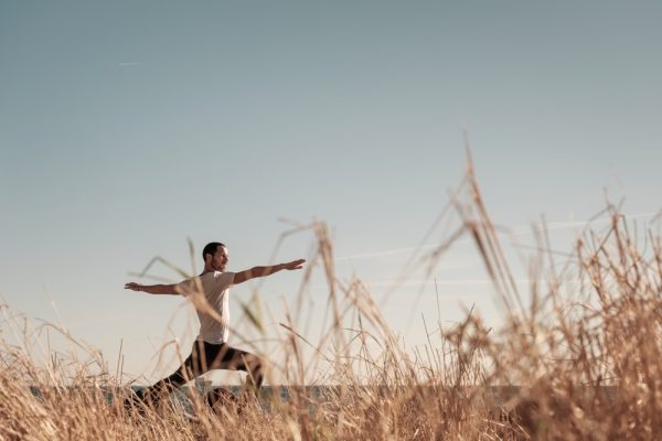 Male adult doing yoga outdoors